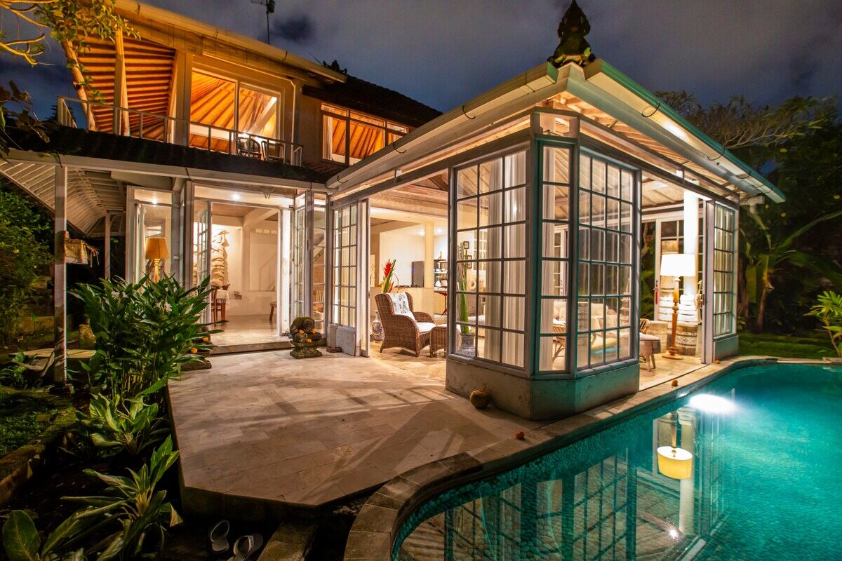 Magic Villa Ubud at dusk, the pool lit from the house