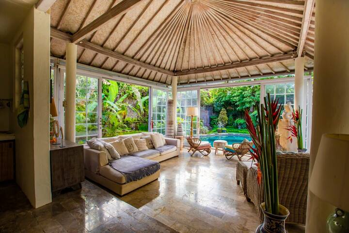 The living room looking out to the pool and garden