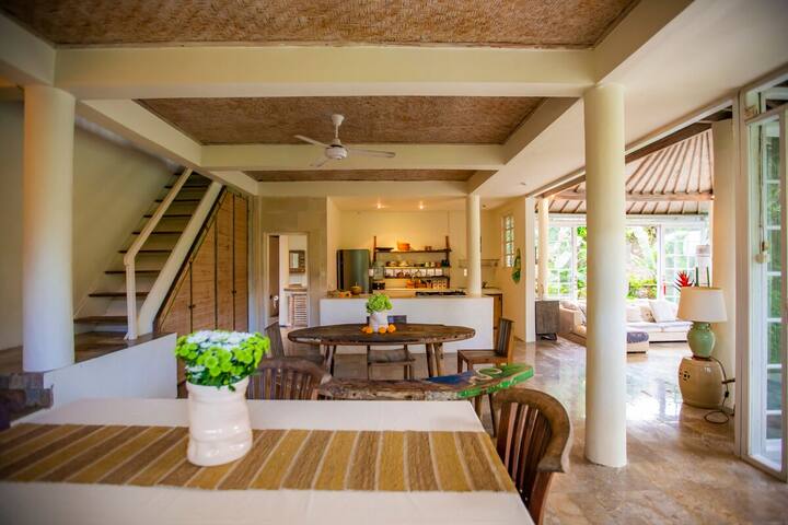 The dining table, with the stairs to the upper floor behind