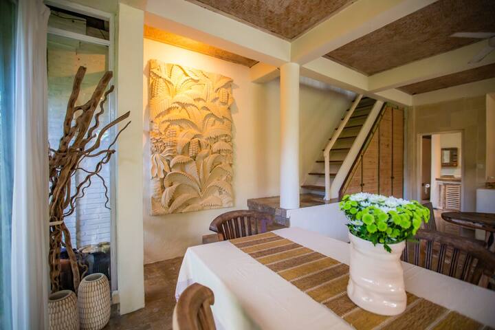 The dining area beside a carved timber panel