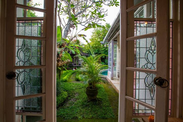 Stained-glass doors opening from the garden bedroom