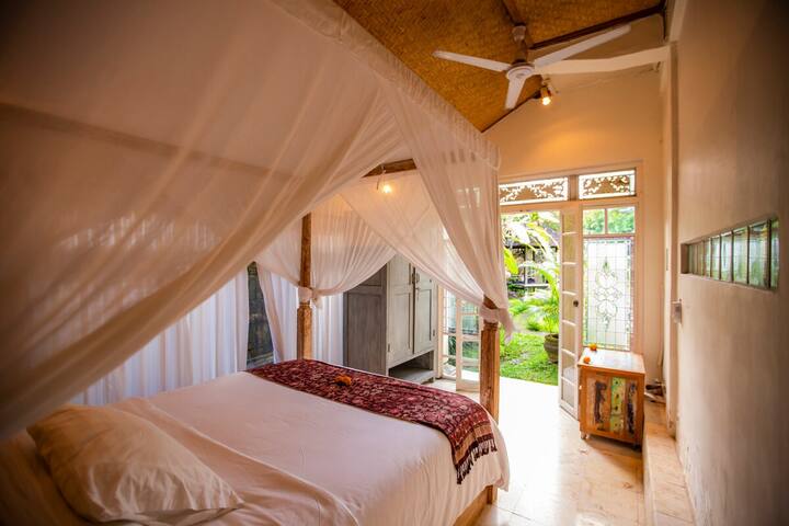 The traditional carved Balinese bed in the garden bedroom