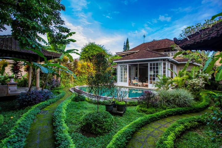 The garden, pool and villa seen from the upper terrace