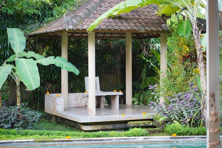 An open bale pavilion beside the pool