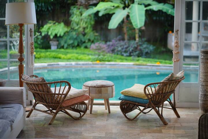 Rattan chairs set out at the poolside
